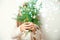 Cute happy little girl Laughing in Christmas atmosphere with gift boxes and magic lights holding spruce branch