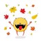 Cute happy monster with falling autumn leaves