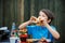 Cute healthy teenager boy eats hamburger and potato