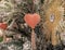 Cute heart and diamond star ornaments hanging on a Christmas pine tree as holiday decoration with snow on the branches