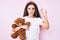 Cute hispanic child girl holding teddy bear annoyed and frustrated shouting with anger, yelling crazy with anger and hand raised