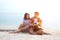 Cute hispanic couple playing guitar serenading on beach