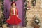 Cute holiday party dress. Small model with fashion look. Fashionable little child. Little fashionista on xmas decoration