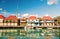 Cute houses with yacht, people at harbor, St. John, Antigua