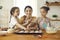 Cute impatient kids can't wait for cookies to be ready while cooking with mom at home