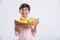 Cute indian/Asian little boy holding Mango basket in hand and giving multiple expressions. isolated over white background