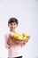 Cute indian/Asian little boy holding Mango basket in hand and giving multiple expressions. isolated over white background