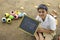 Cute indian child studying at home, writing shiksha word in marathi language on Slate board