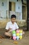 Cute indian child studying at home, writing shiksha word in marathi language on Slate board