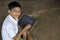 Cute indian child studying at home, writing shiksha word in marathi language on Slate board