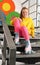 Cute indie girl with roller skates sitting on stairs indoors