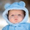 Cute infant baby boy wearing fluffy snow suit