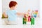 Cute infant baby playing with wooden hammer block toy