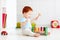 Cute infant baby playing with wooden hammer block toy