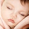 Cute infant baby sleeping, beautiful kid`s face closeup
