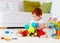 Cute infant redhead baby playing with toys at home