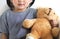 Cute and innocent child with teddy on white background