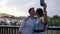 Cute interracial couple takes selfie in the sunset with smartphone