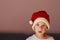 A cute isolated child wearing a knitted Santa hat. Xmas design