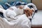 Cute jack russell dog sleeping on the warm jacket of his owner. Dog resting or having a siesta, daydreaming.