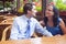 Cute joyful couple at restaurant table