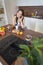 Cute joyous Asian girl sitting at breakfast