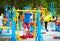 Cute kid, boy exercising on sport ground with other people on background