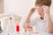 Cute kid boy in glasses making science experiments. Little child working with liquids