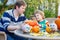 Cute kid boy and his father making jack-o-lantern for halloween