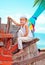 Cute kid, boy sitting on old boat on tropical beach