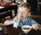 Cute kid drinking milk for breakfast