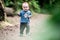 Cute kid eating bread outdoors