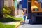 Cute kid is getting on the bus, ready to go to school