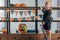 cute kid on ladder hanging flags with happy halloween inscription