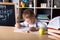 Cute Kid is learning in class on background of blackboard. Teachers day. Talented child. Cute little preschool kid with glasses in