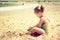 Cute kid playing at the beach. filtered image, retro style