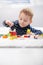 Cute kid playing on floor at home