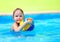 Cute kid playing water sport games in pool