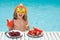 Cute kid in pool with summer fruits. Kids summer vacation. Beach and sea water fun. Summer vacation and holidays