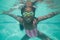 Cute kid posing underwater in pool