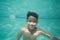 Cute kid posing underwater in pool