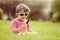 Cute kid with sunglasses, eating chocolate lollipop