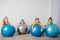 Cute kids balancing laying on large fitballs