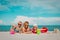 Cute kids -boy and girls- play with toys and sand on beach