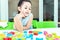 Cute kids female playing with toy designer on the floor at home. Child girl exciting while playing with alphabet colorful blocks.