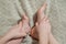 cute kids foot together on gray wool carpet