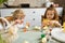 Cute kids getting ready for Easter. Children paint eggs before the holidays.