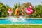 Cute kids jumping in swimming pool with swim rings
