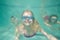 Cute kids posing underwater in pool