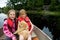 Cute kids and a puppy on a lake